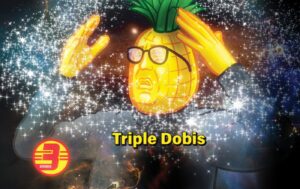 A person with a pineapple head and glasses raises their hands in amazement amid sparkles. "Triple Dobis - Hazy Triple IPA" is centered, with the Dobis logo in the bottom left.