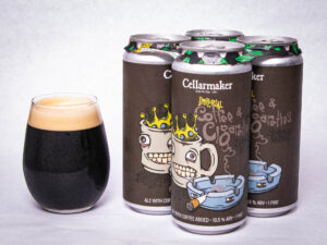 A glass of dark beer sits beside four cans of Imperial Coffee & Cigarettes - Coffee Porter, each labeled with cartoon mugs wearing crowns and a blue ashtray.