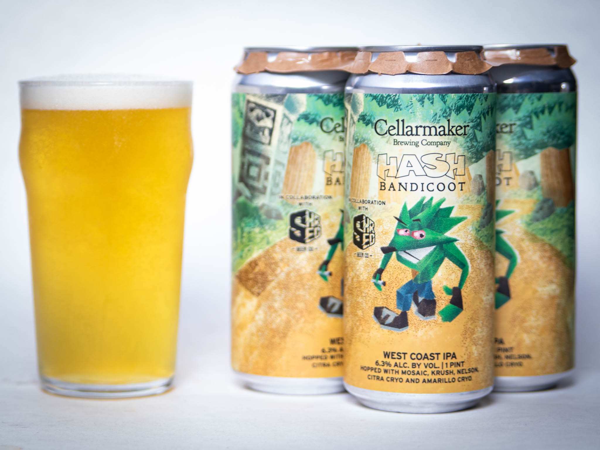 A Pint Glass Filled With Hazy Yellow Beer Sits Next To Three Cans Labeled &Amp;Quot;Christopher Riwakan - Hazy Pale Ale,&Amp;Quot; Featuring A Vibrant Design With Hops And Greenery In The Background.
