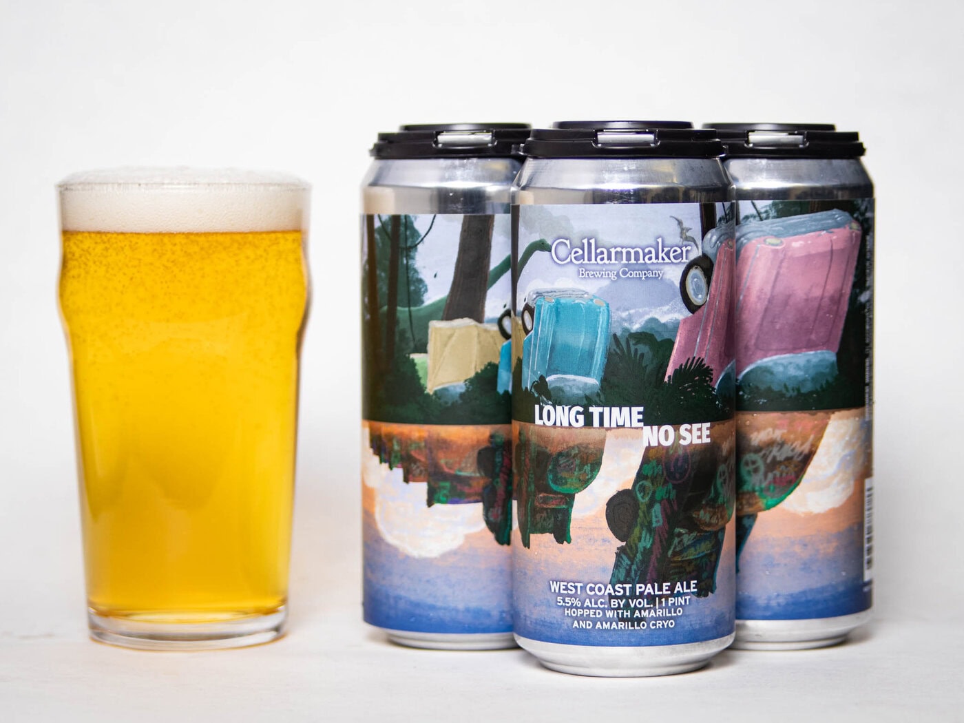 A Pint Glass Filled With Pale Beer Sits Beside A Four-Pack Of Cellarmaker Cans Labeled &Quot;Long Time No See&Quot; West Coast Pale Ale, Featuring Colorful, Retro Cars And A Scenic Design On The Cans.