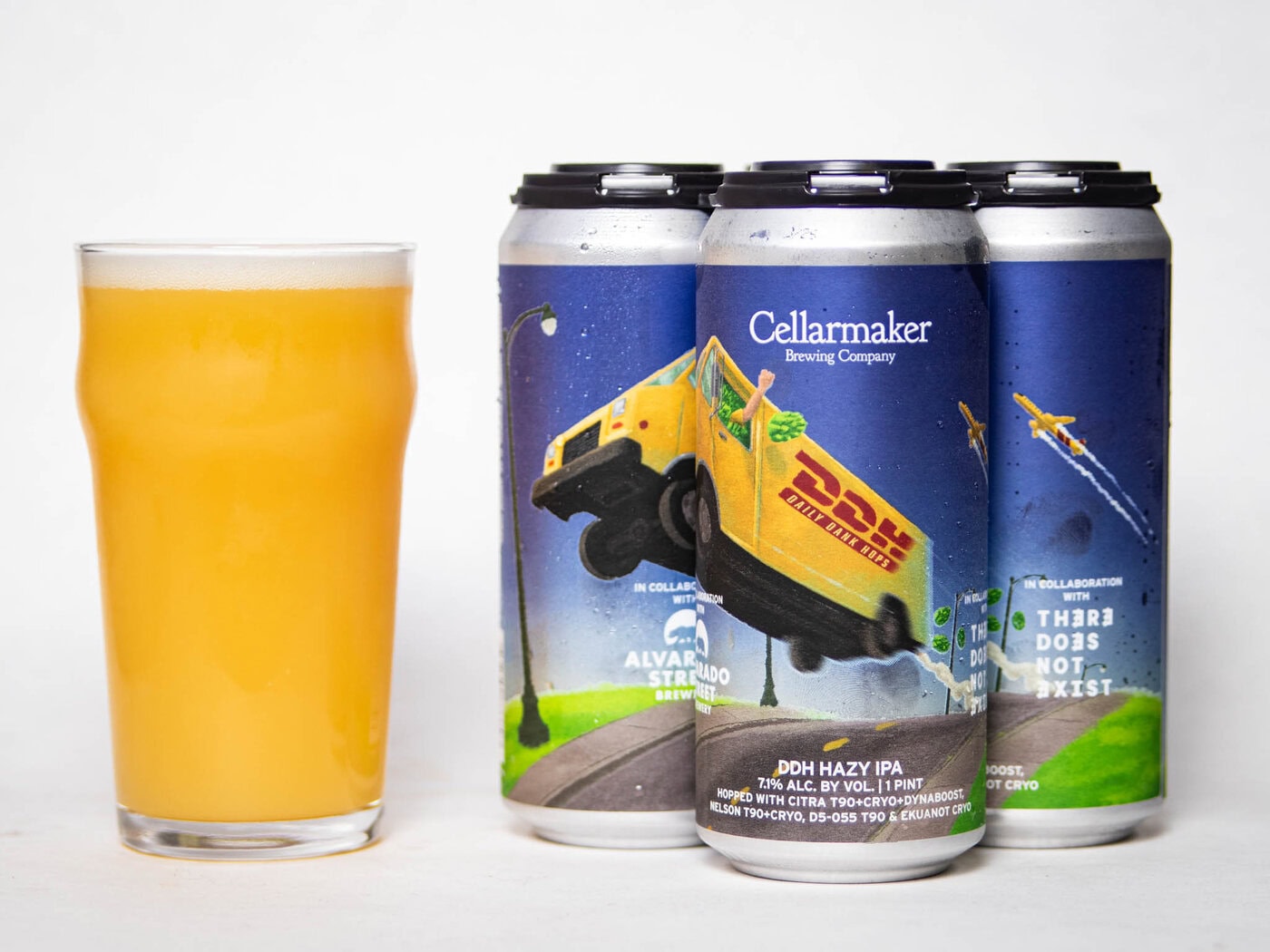 A Glass Of Hazy, Light Yellow Beer Sits Next To Four Cans Of Cellarmaker Brewing Company’s Ddh Hazy Ipa, Featuring Colorful Artwork Of A Flying Van On A Surreal Street Scene.